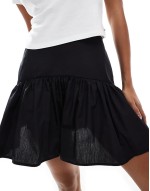 dropped waist mini skirt in black